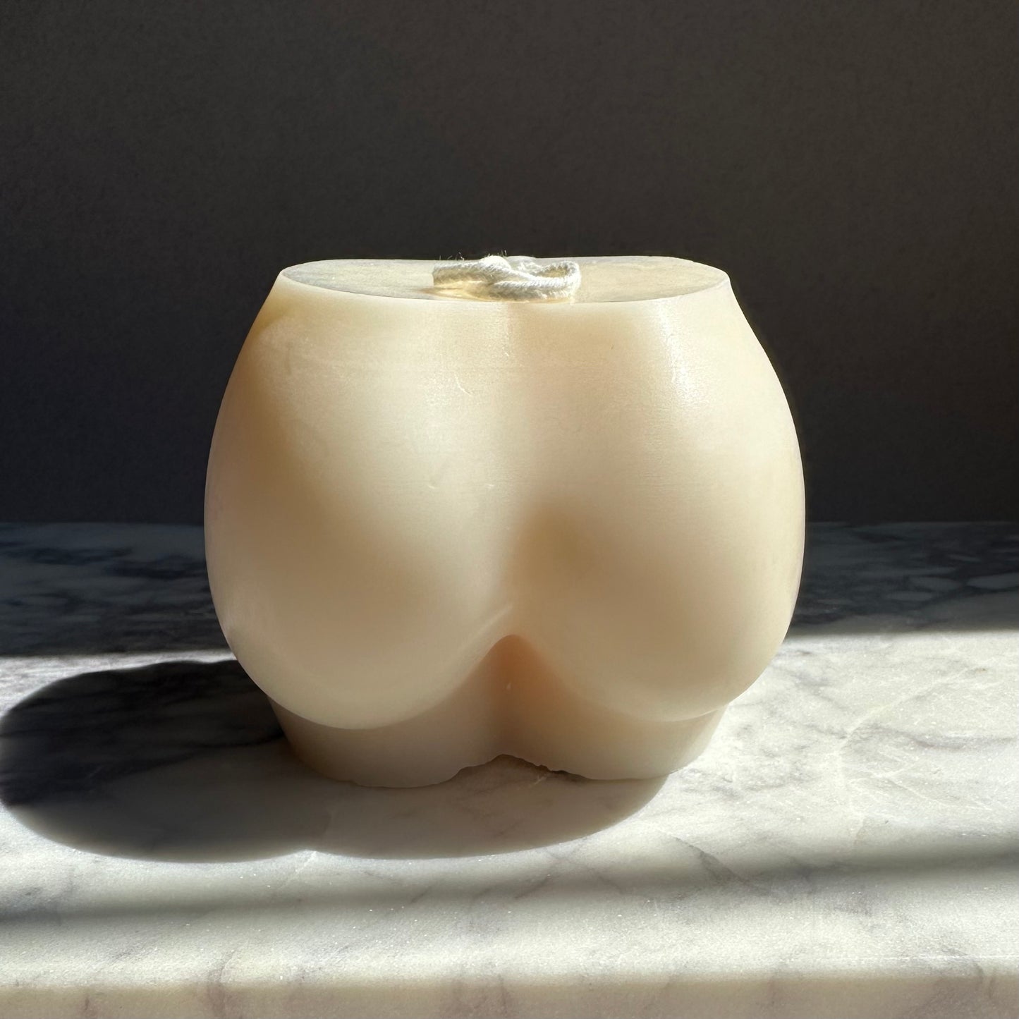 ivory bum shaped candle nude tones
